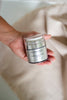 Hand holding Flora Lane Barrier Restore Cream on cream linen — best moisturiser for menopausal skin NZ